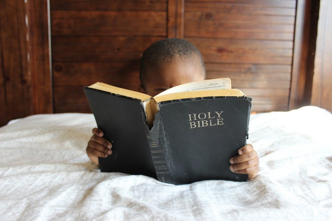 how boys become men; boy reading bible
